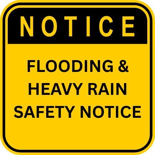 Yellow notice sign that states flooding and heavy rain safety notice