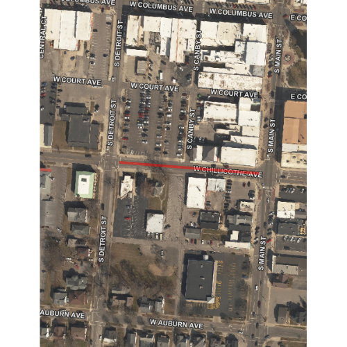Aerial view of a town, showing streets and buildings. Main roads include W Court Ave and W Chillicothe Ave. The setting is urban with parking lots.