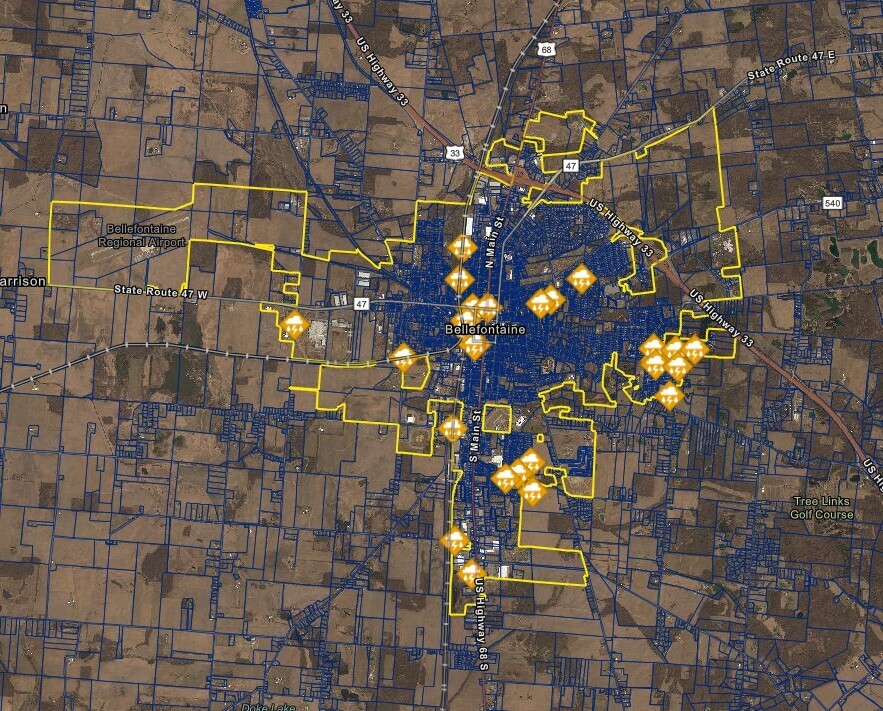 Aerial map of Bellefontaine, Ohio with highlighted yellow boundaries and icons indicating key locations. Major highways and streets visible.