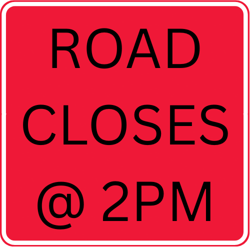 Red sign with white border. Bold black letters read "ROAD CLOSES @ 2PM" in uppercase.