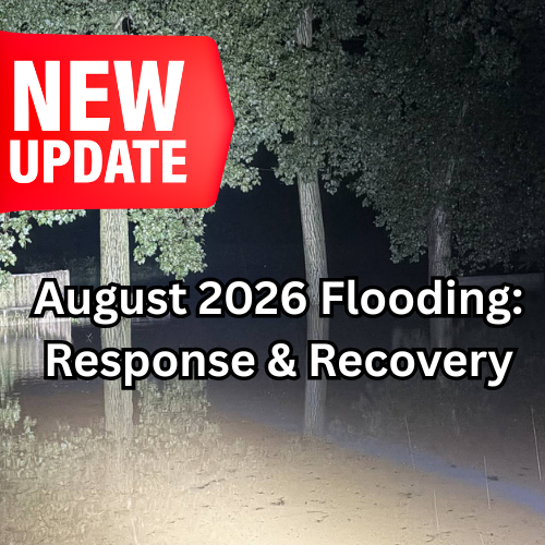 Bright red banner reads "NEW UPDATE" over dark image of flooded ground with trees. Text below banner reads "August 2026 Flooding: Response & Recovery."