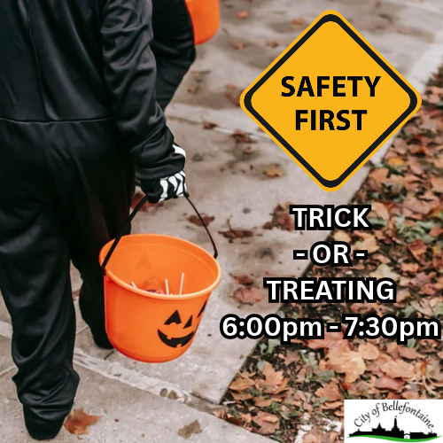 Person in Halloween costume carrying orange bucket walking on sidewalk. Leaves on ground. Safety sign with text.