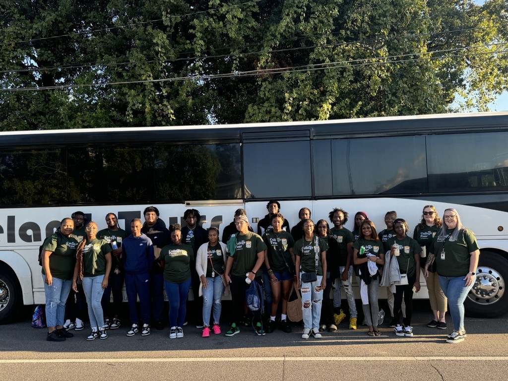 College Tour attendees in front of charter bus at City Hall