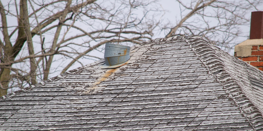 a roof with peeling shingles