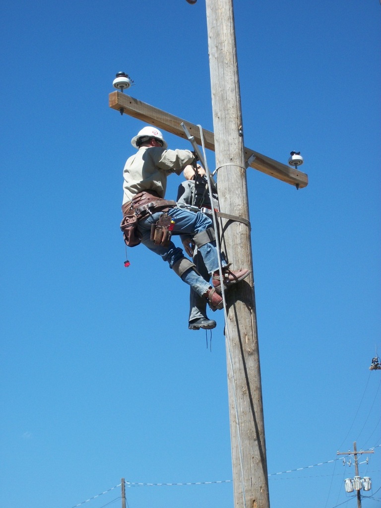 Lineman climbing an electrical pole
