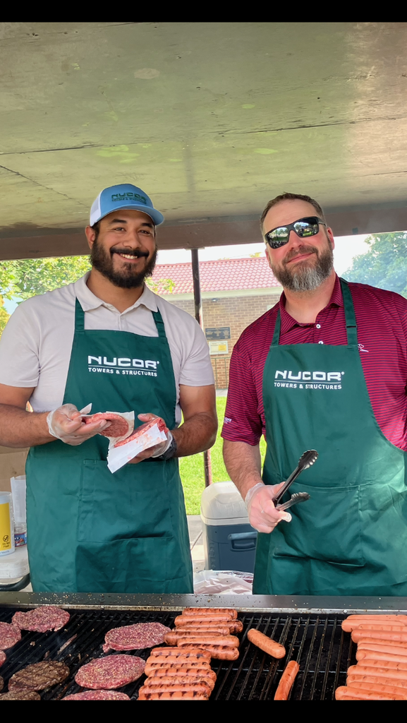 Nucor employees prepare food for the community barbecue