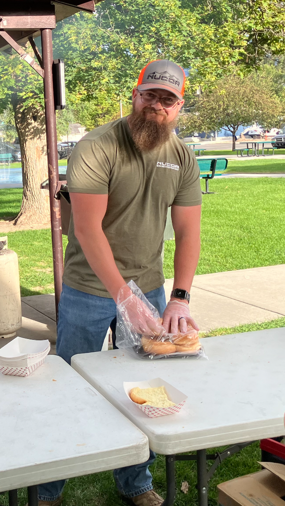A Nucor employee prepares food at the community barbecue