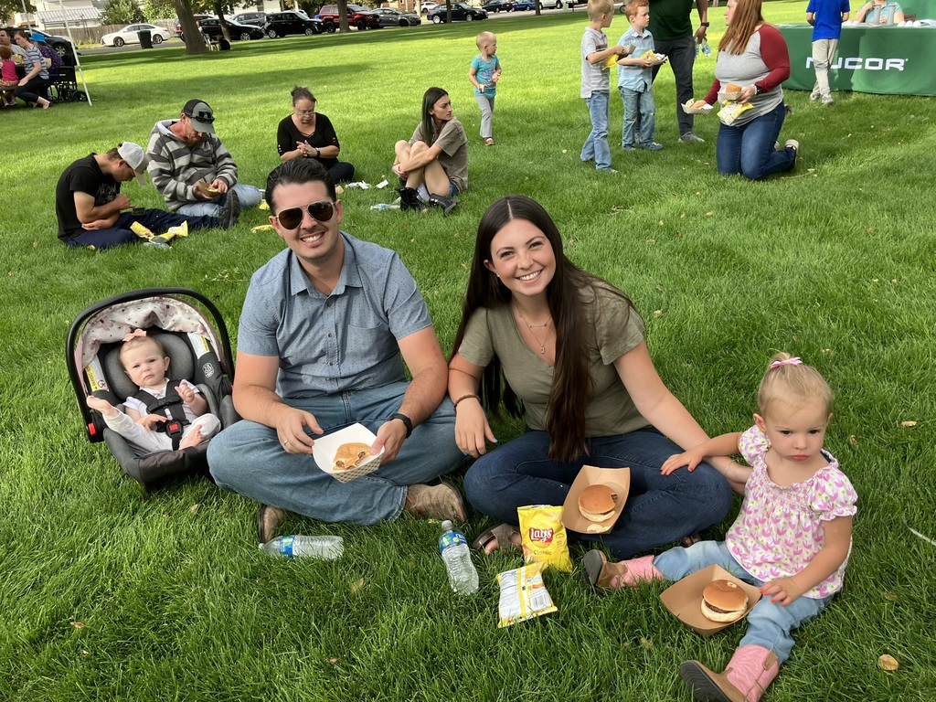 a family enjoys the community barbecue