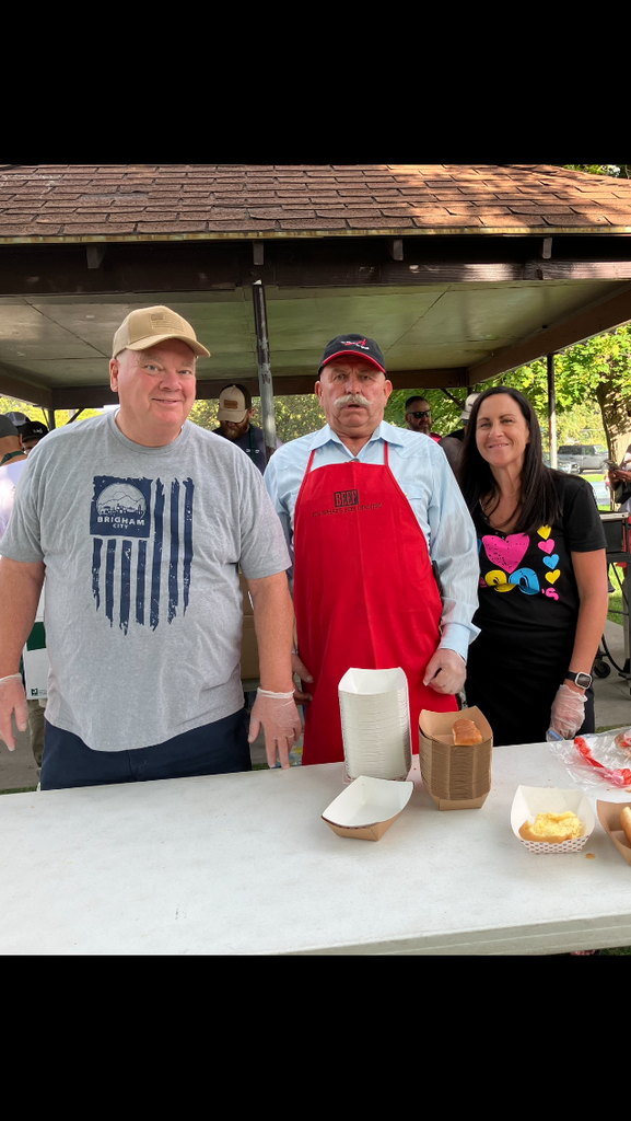 volunteers serve food at the community barbecu
