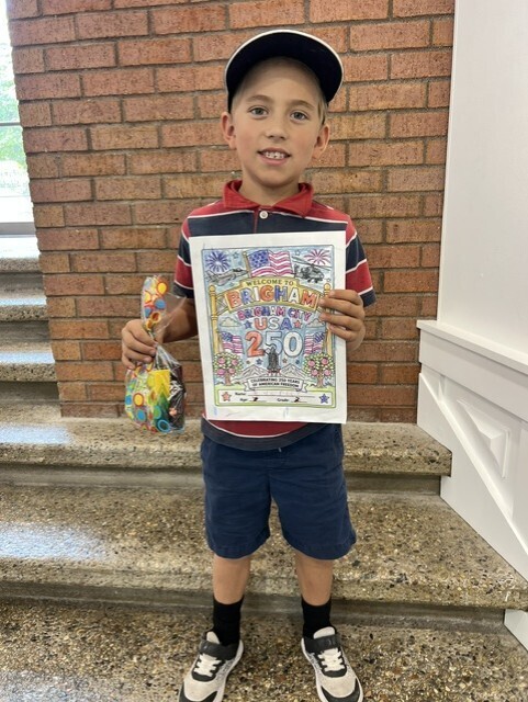 Everest holding his prize and the picture he colored