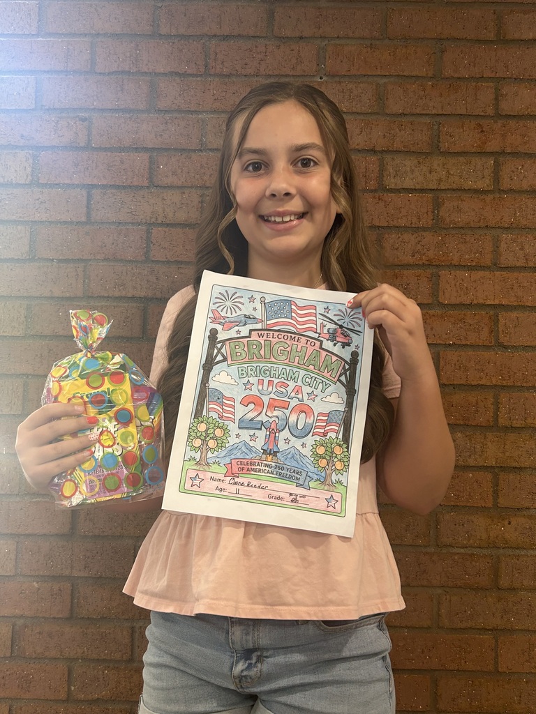Clair holding her prize and the picture she colored
