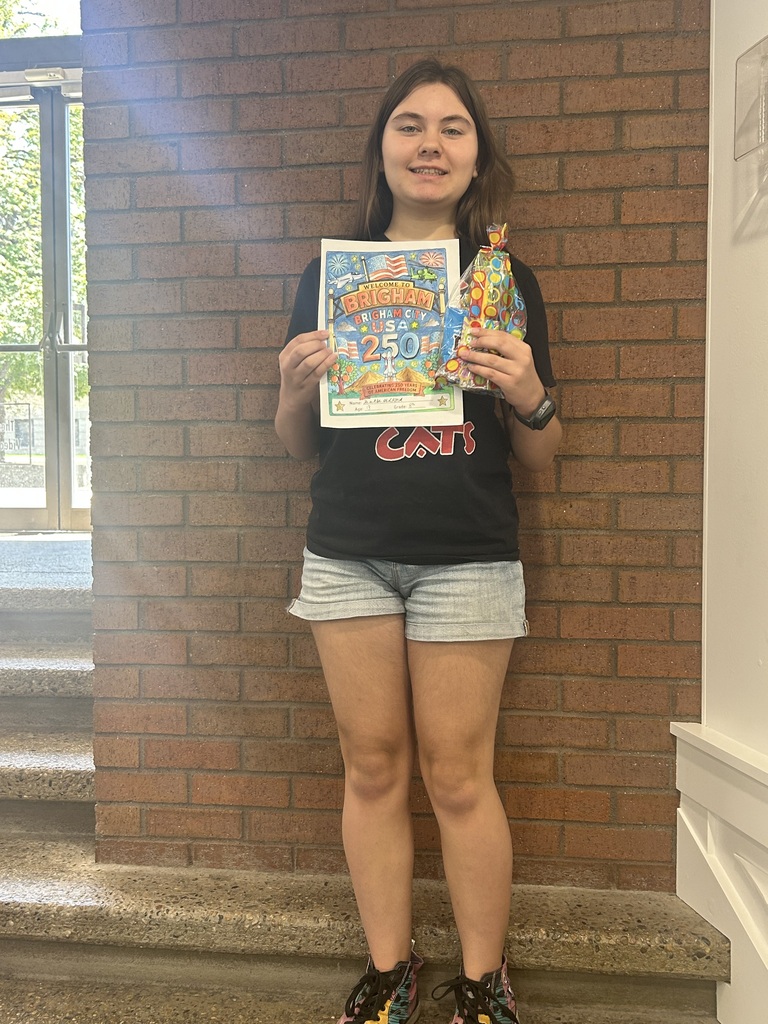 Darla holding her prize and the picture she colored