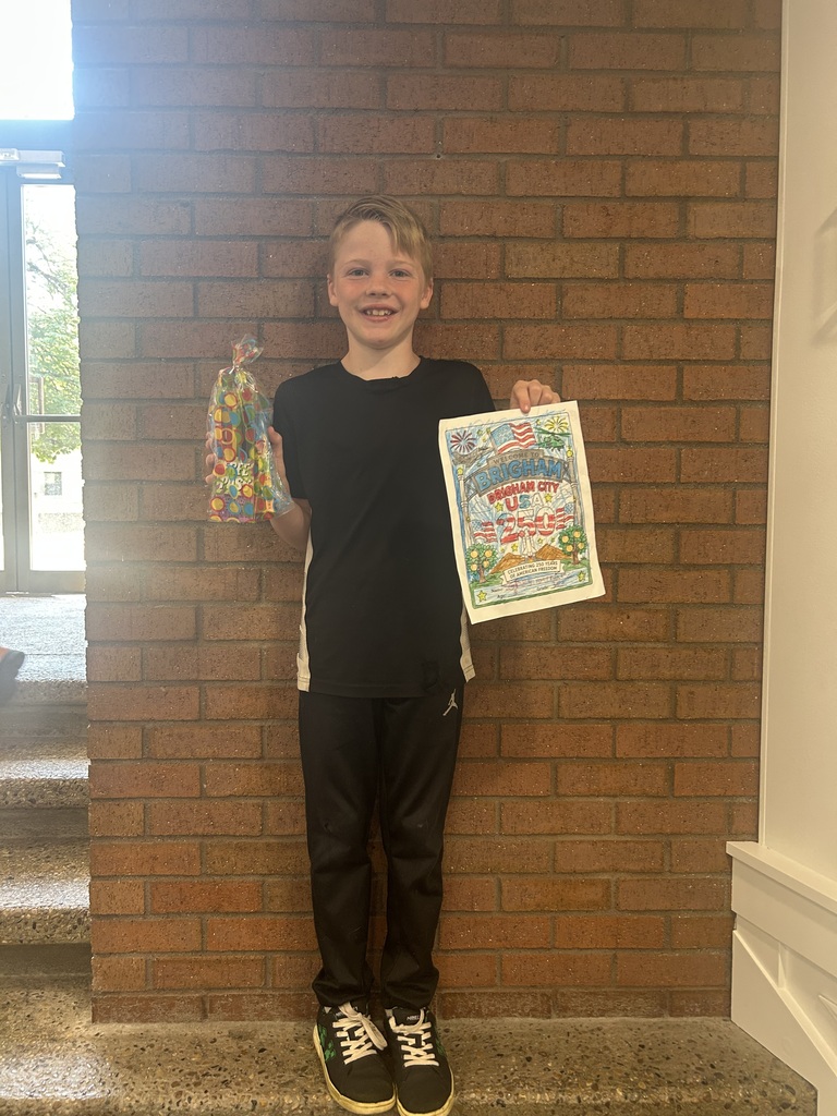 Grey holding his prize and the picture he colored