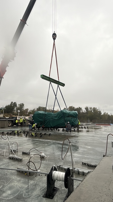 a crane moves a generator into place
