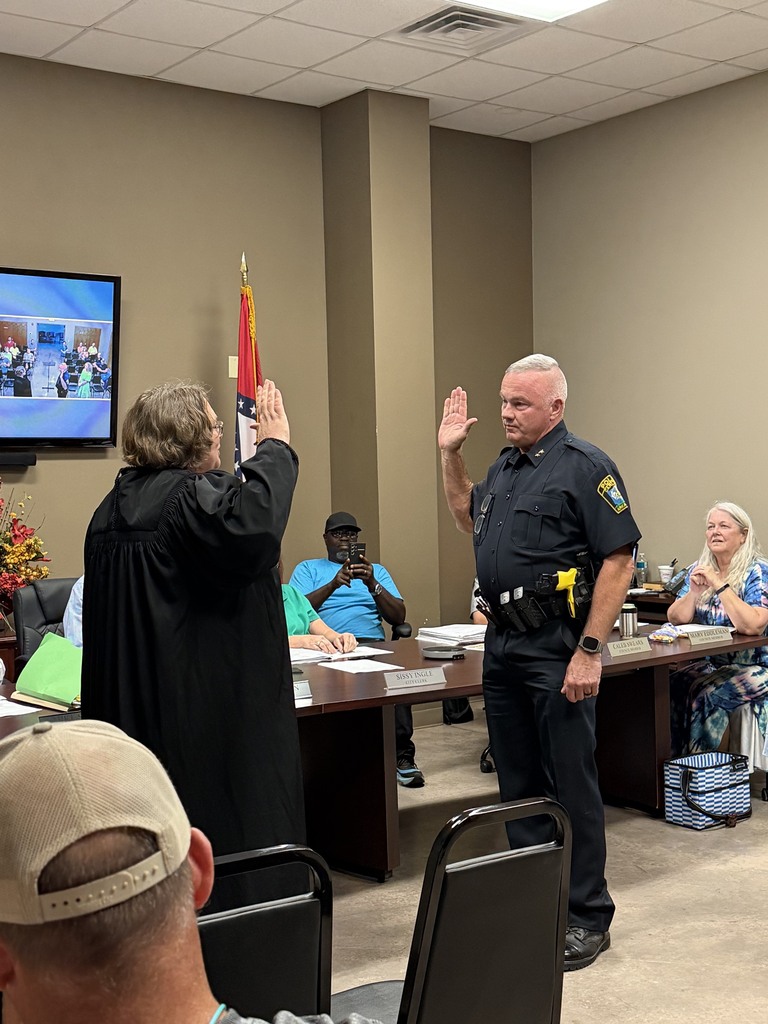Chief of Police being sworn in by the local judge