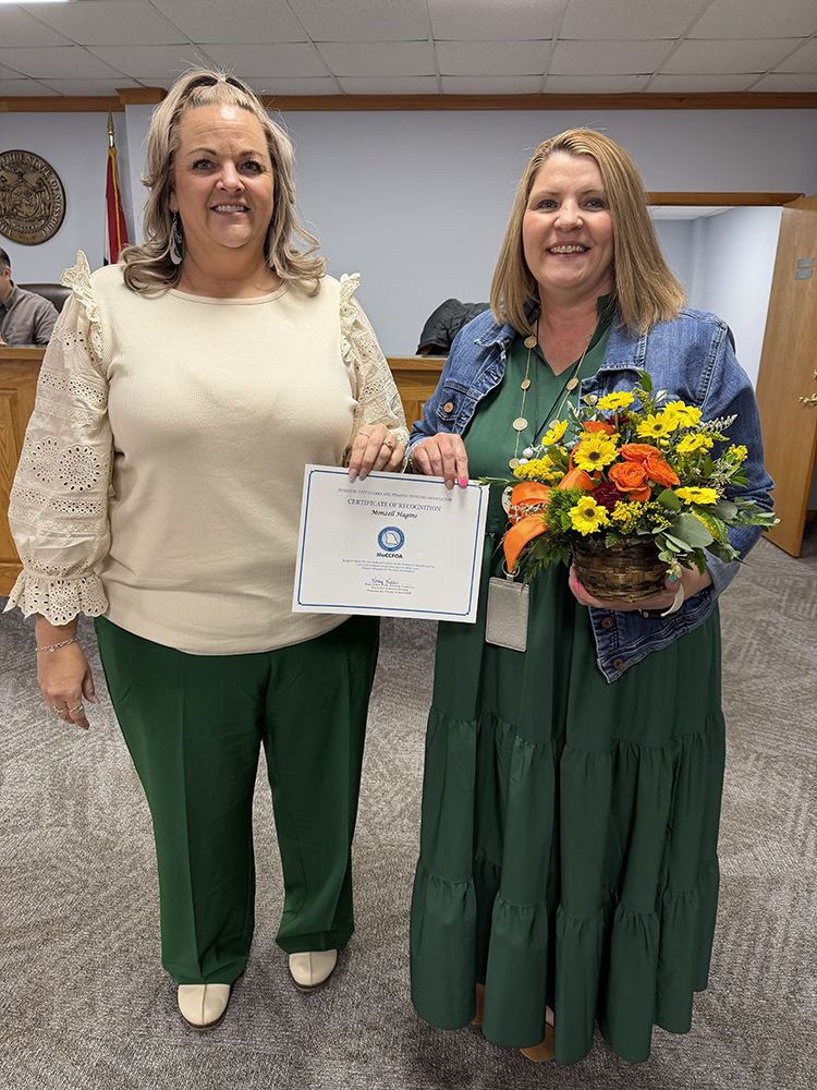 two women holding certificate