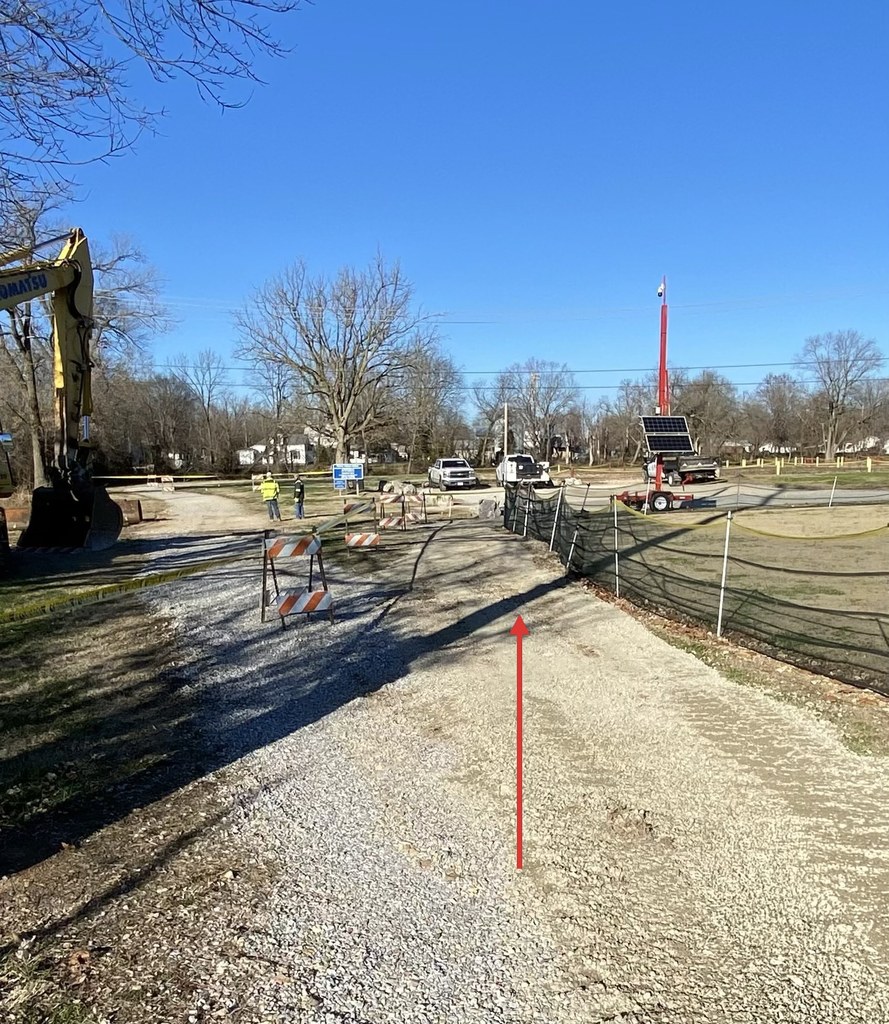 Arrow pointing to open Greenway Trail path