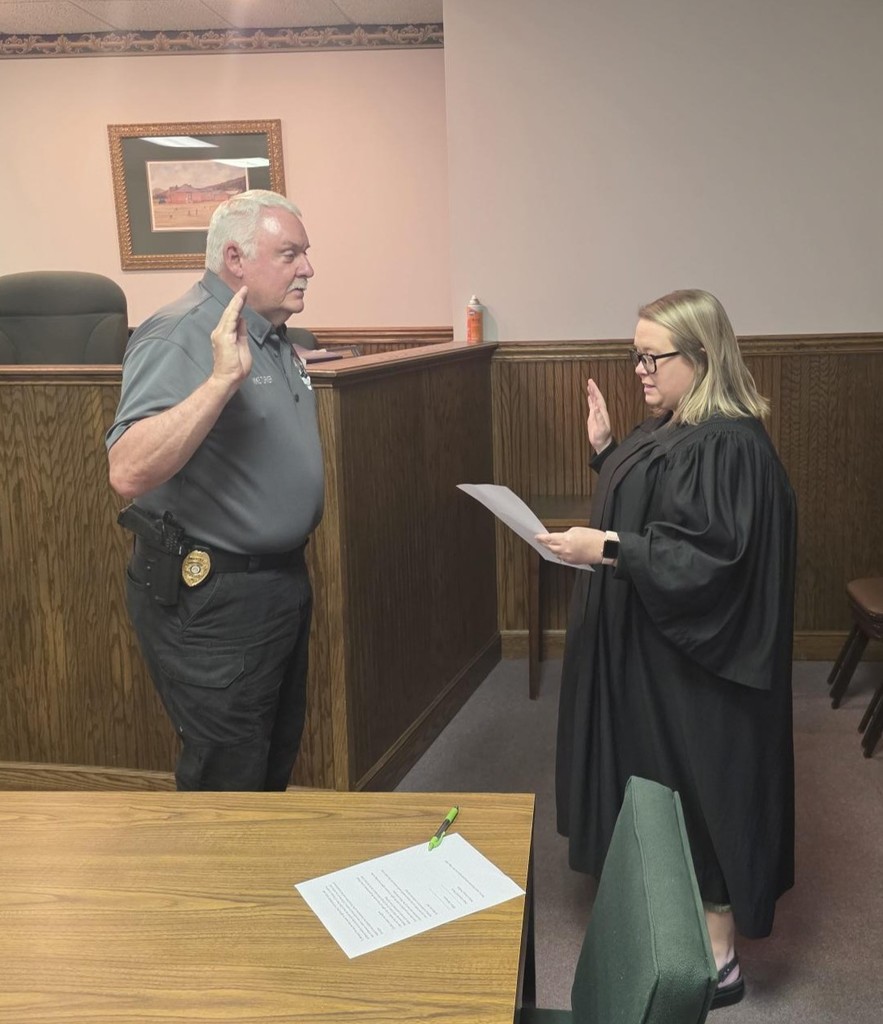 Probate Judge Dixon administering the oath of office to new Clayton Police Chief Mike Turner