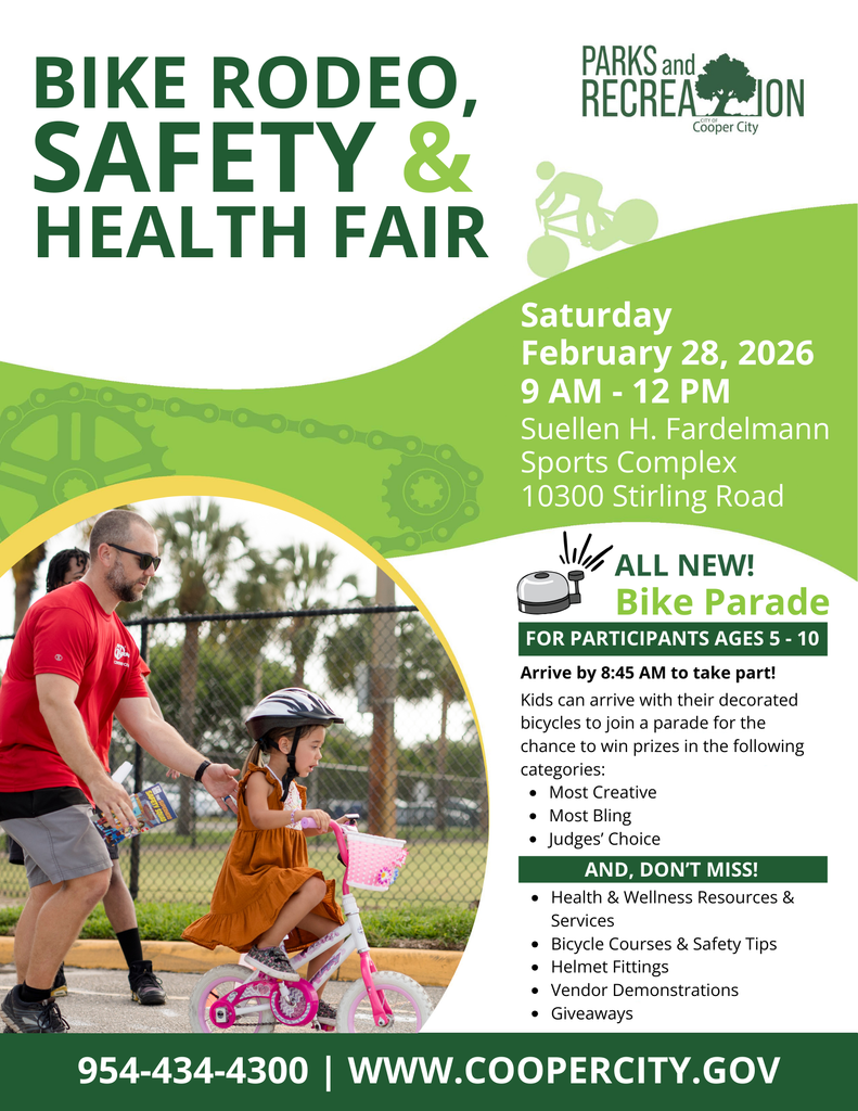 Young girl on bicycle with adult behind her