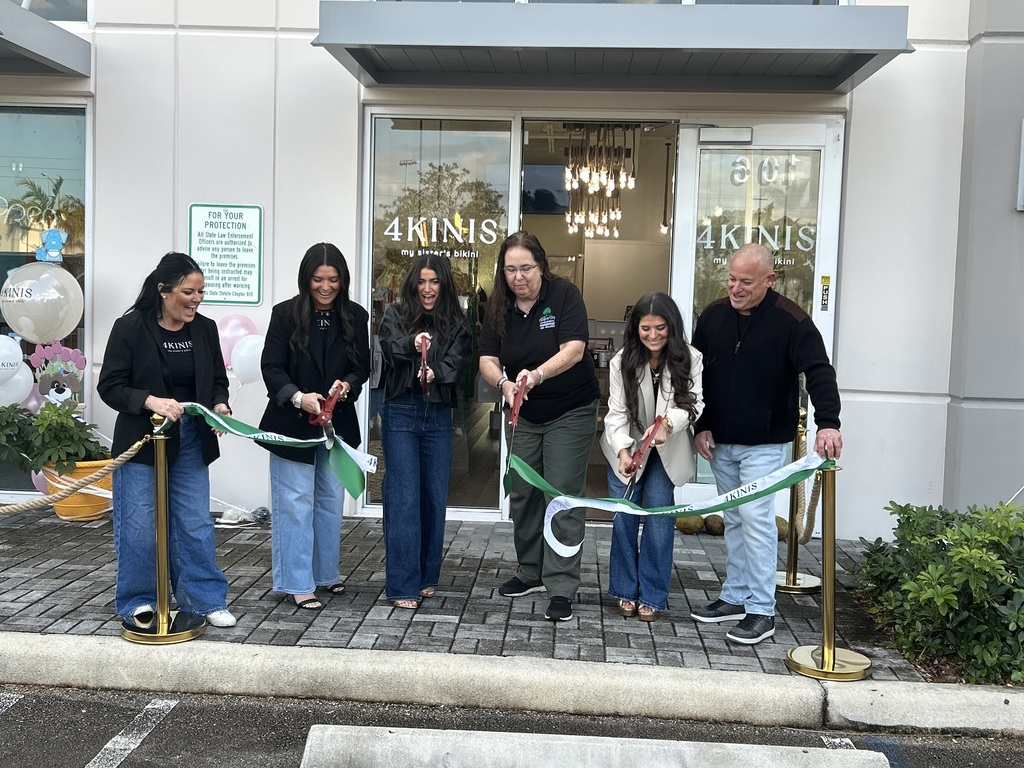 Commissioner Lisa Mallozzi joined by business owners in ribbon cutting