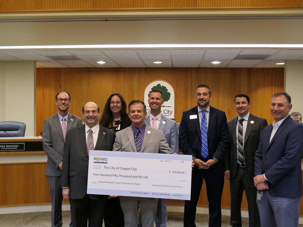 Elected officials holding a celebratory check from Broward County, for $450,000