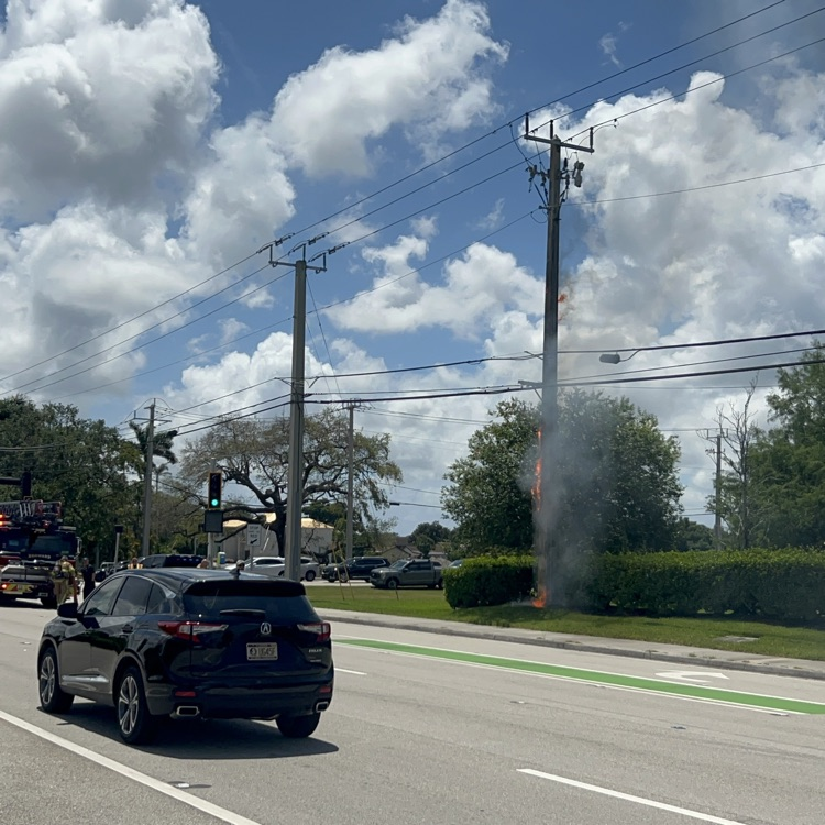 power pole on fire and emergency vehicles
