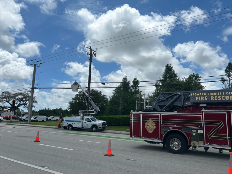 First responder vehicles next to a power pole