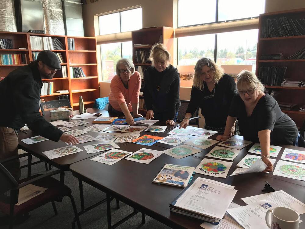 An image of members of the Park and Tree Advisory Board looking over paperwork during one of their meetings.