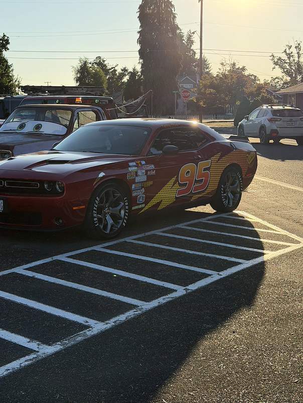 Image of a car painted and decorated to look like Lightning McQueen from the Cars franchise