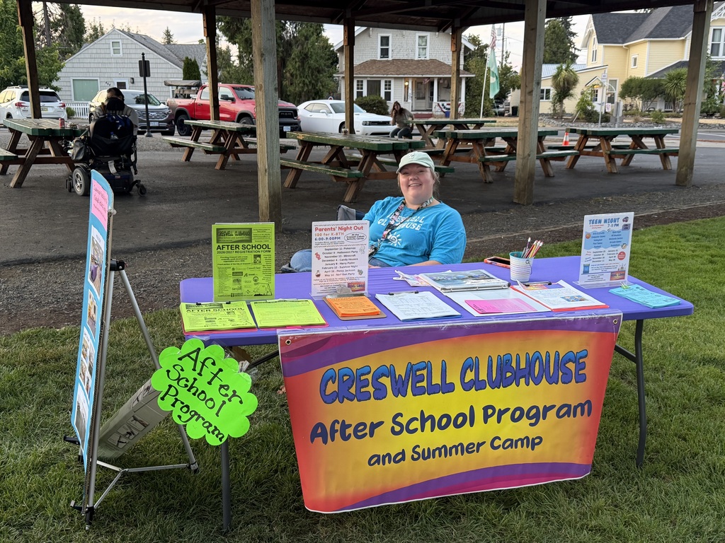 Image of Cass, the Creswell Clubhouse Program Coordinator, at the Creswell Clubhouse booth at Movies in the Park