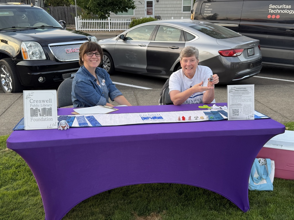 Image of Jordan and Nancy at the Creswell Public Library Foundation booth at Creswell's Movies in the Park event