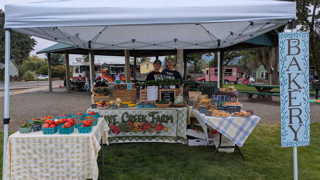 Image of the Olive Creek Farm booth at the August 15th, 2026, Creswell Farm to Table event.