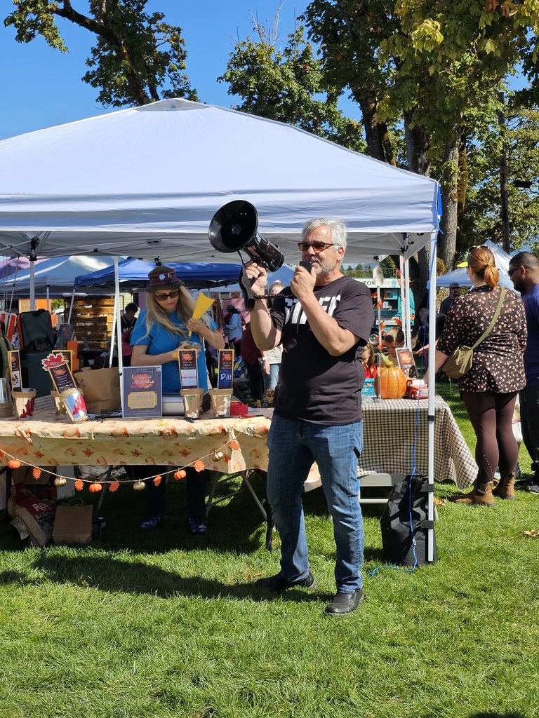 Image of City Manager Vincent Martorello with a megaphone preparing to announce the raffle winners at the Creswell Fall Festival