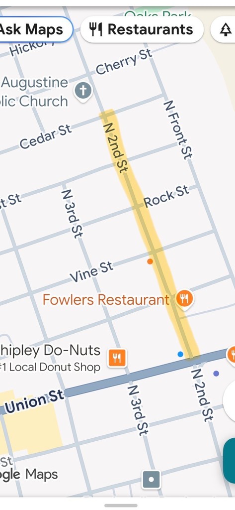 Screenshot of Google Maps showing a highlighted yellow section of North 2nd Street in downtown Dardanelle, Arkansas, between Cedar Street and Union Street. Nearby landmarks include Fowler’s Restaurant, Shipley Do-Nuts, and St. Augustine Catholic Church. The highlighted route indicates a road work or traffic alert along the street.