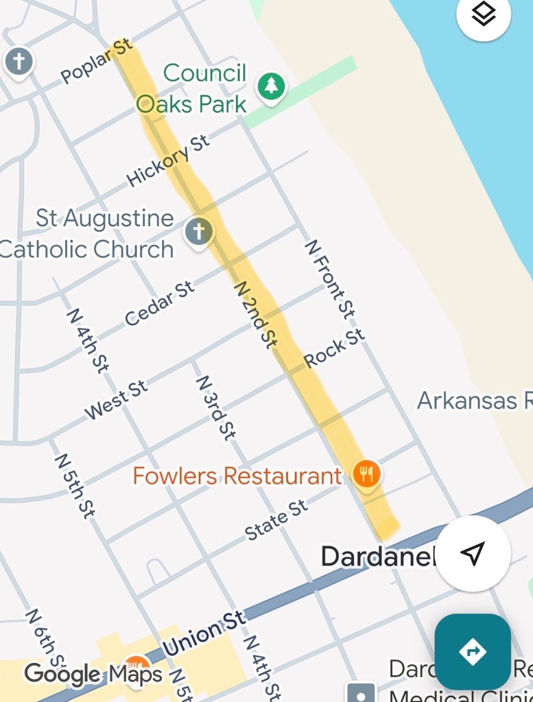 Map of Dardanelle, Arkansas highlighting a section of North 2nd Street in yellow from Union Street north past Rock Street, Cedar Street, and Hickory Street to Poplar Street. Nearby landmarks include Council Oaks Park, St. Augustine Catholic Church, and Fowlers Restaurant. The Arkansas River runs along the right side of the map.