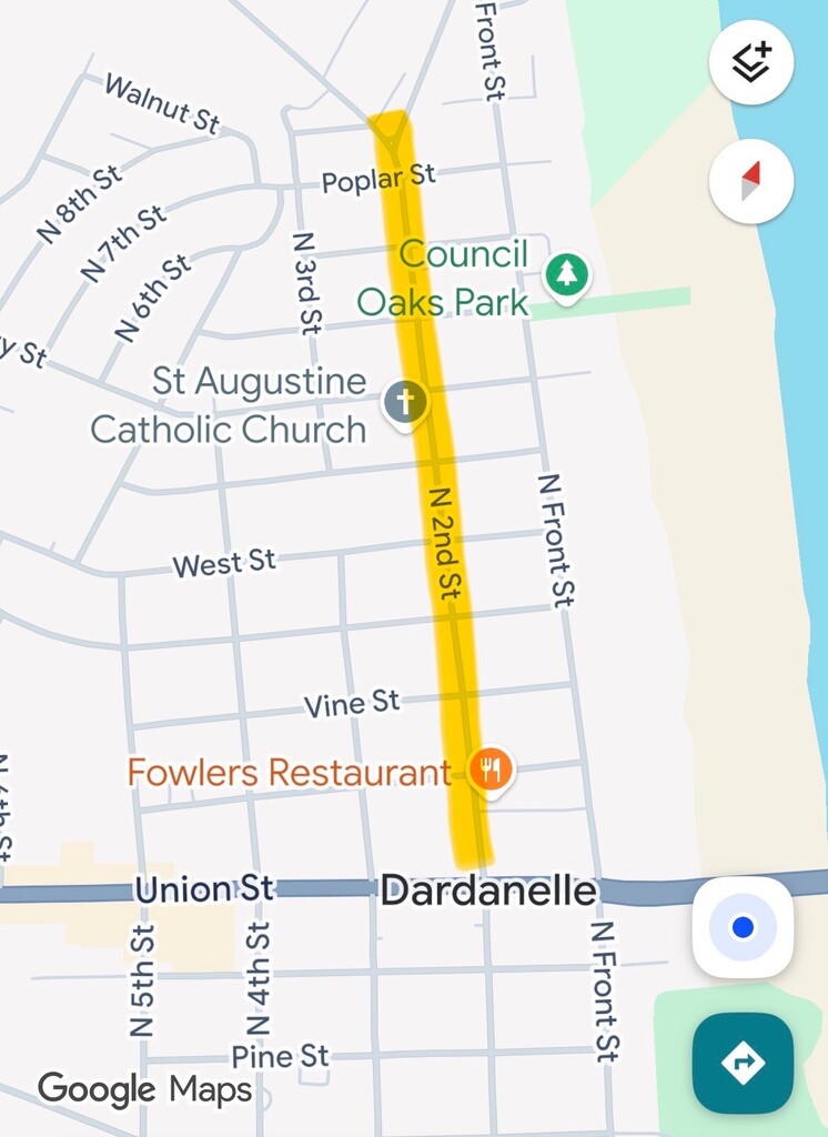 Screenshot of a Google Maps view of downtown Dardanelle, Arkansas, showing a highlighted construction area along North 2nd Street. The highlighted route extends north from Union Street past Vine Street, West Street, and Poplar Street. Nearby landmarks include Council Oaks Park, St. Augustine Catholic Church, and Fowlers Restaurant. The Arkansas River appears along the right side of the map, and the highlighted section is shaded in yellow to indicate the construction zone.