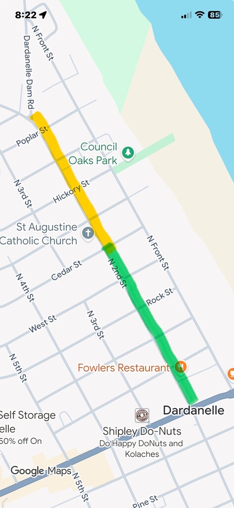 Screenshot of a Google Maps view of Dardanelle showing North 2nd Street highlighted in two colors to indicate construction access. The section from downtown near Fowler’s Restaurant north to Cedar Street is marked in green, indicating it is open. The section from Cedar Street north past Hickory Street toward Poplar Street and Dardanelle Dam Road is marked in yellow, indicating a construction area or traffic restriction. Nearby landmarks shown include Council Oaks Park, St. Augustine Catholic Church, Fowler’s Restaurant, and Shipley Do-Nuts.