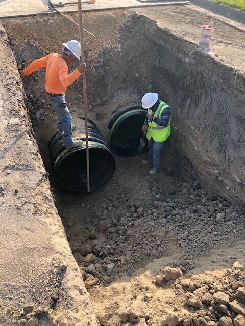 workers install drainage pipe