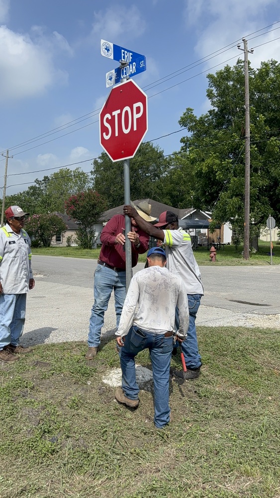 Street crews install new stop sign