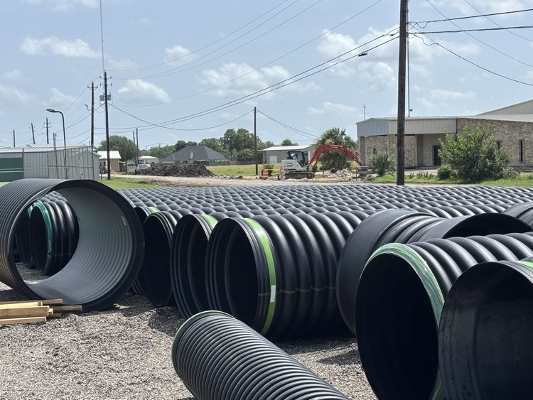 pipes wait for placement on Miracle Drive