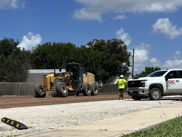 Work continues on Miracle Drive by Edna High School .