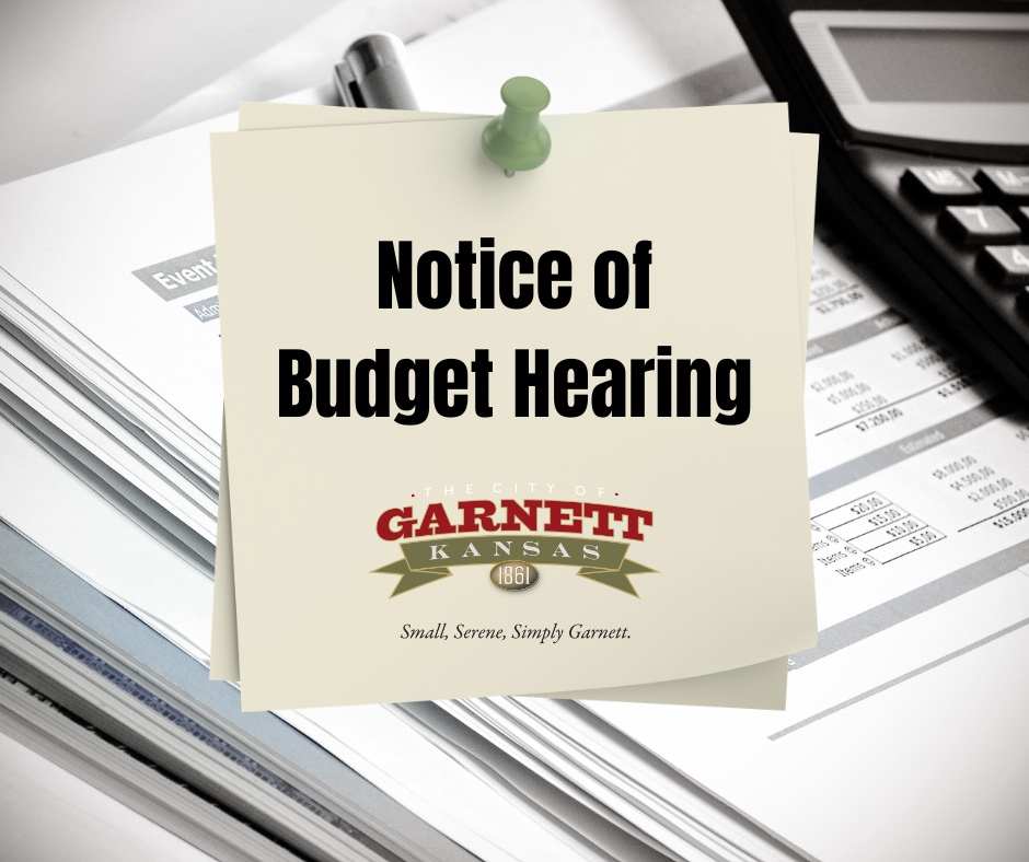 notice of budget hearing with calculator and stack of financial papers