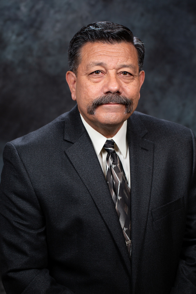 Mayor Al Gameros in a dress suit with a dark grey background