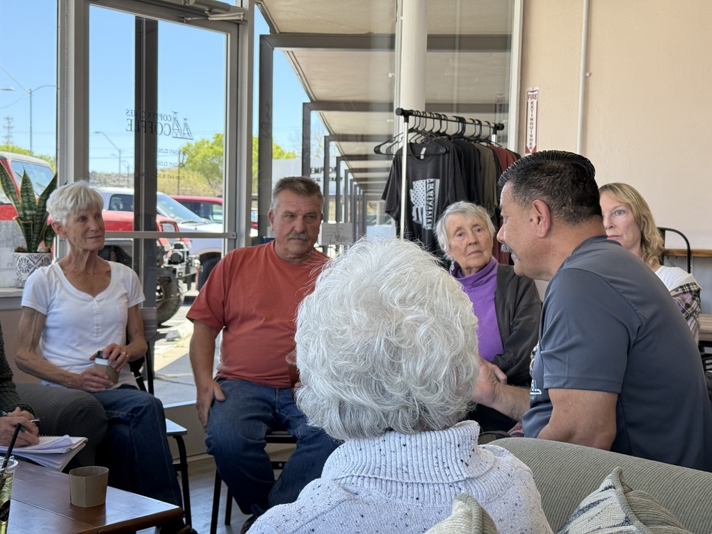 Group of people sitting with Mayor Gameros in deep discussion