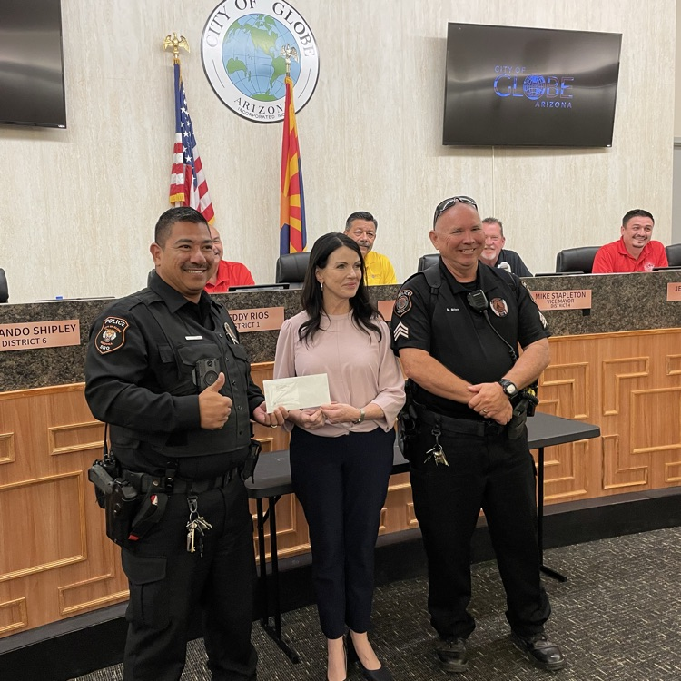 Photo of officers accepting grant funds from Robin with Freeport McMoRan
