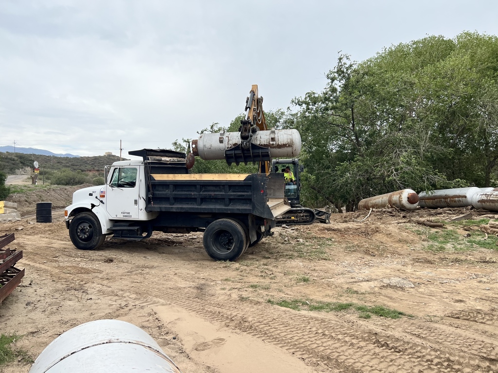 Photo of a propane tank being loaded onto a 10-wheeler truck