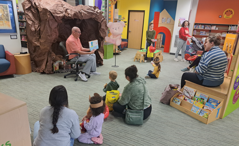 Grand Island City Councilmember Jack Sheard reading to kids during the 2025 Bear Fair