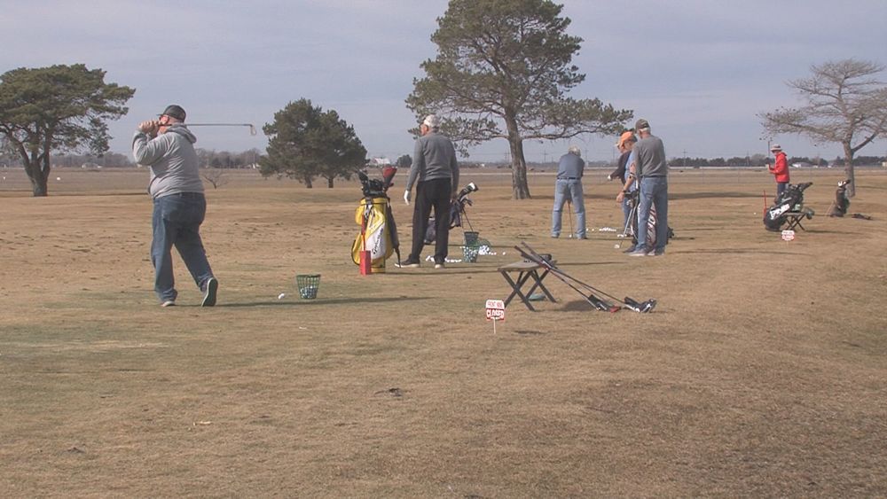 Golfers Hitting Range Balls