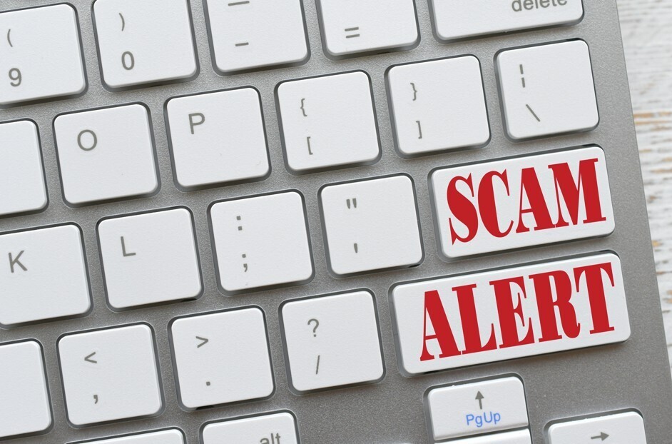 Keyboard with the words "Scam Alert" in Red on it