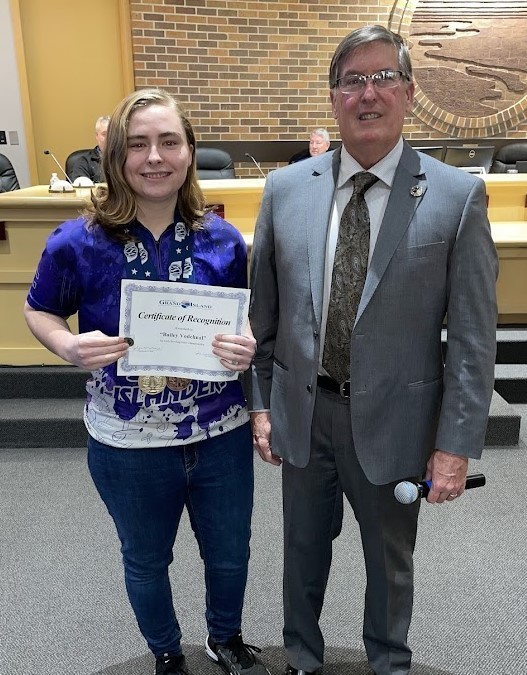 Grand Island Senior High bowler receiving a certificate from Mayor Steele